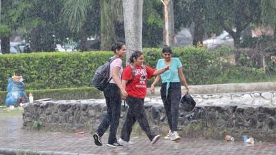 Students caught in the rain at Panjab University in Chandigarh. (Ravi Kumar/HT) Students caught in the rain at Panjab University in Chandigarh. (Ravi Kumar/HT)