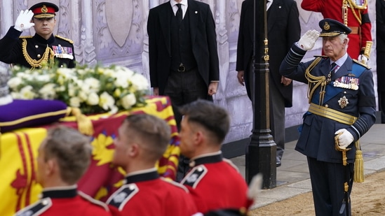 Queen Elizabeth II's Funeral: Britain's King Charles III, salutes as the coffin of Queen Elizabeth II is carried into the Palace of Westminster.(AFP)