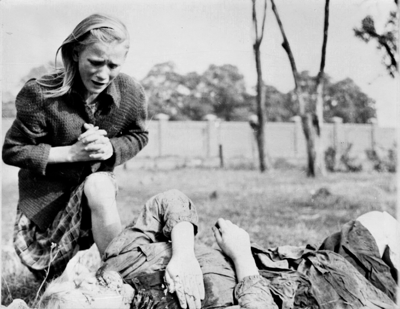 Julien Bryan captured a 12-year-old Polish girl grieving over the body of her sister, whom a German soldier shot. Millions of such children in Poland mourned their family and friends.&nbsp; (Wikimedia Commons)