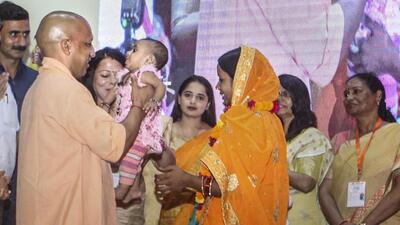 Uttar Pradesh Chief Minister Yogi Adityanath interacts with a child after the launch of ‘National Nutrition Month’, in Lucknow on Friday. (PTI PHOTO)