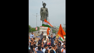 Yuva Rajput Sabha members celebrate the announcement of a public holiday on the birthday of Maharaja Hari Singh by the J & K government, near his statue in Jammu on Friday. (PTI) Yuva Rajput Sabha members celebrate the announcement of a public holiday on the birthday of Maharaja Hari Singh by the J & K government, near his statue in Jammu on Friday. (PTI)