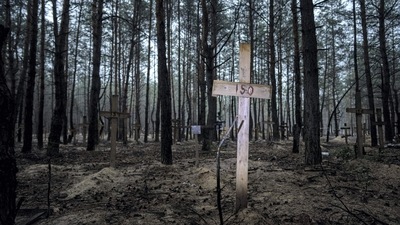 A view of unidentified graves of civilians and Ukrainian soldiers in a cemetery in the recently retaken area of Izium, Ukraine, Thursday. (AP)