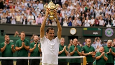 Switzerland's Roger Federer is applauded by ground staff as he holds the trophy after defeating Croatia's Marin Cilic to win the Men's Singles final match in 2017 (AP) Switzerland's Roger Federer is applauded by ground staff as he holds the trophy after defeating Croatia's Marin Cilic to win the Men's Singles final match in 2017 (AP)
