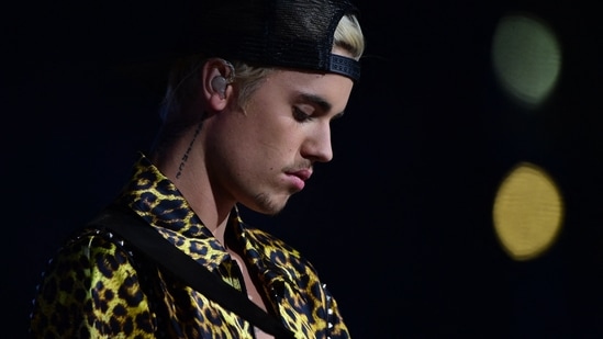 In this file photo taken in 2016 singer-songwriter Justin Bieber waits onstage during the 58th Annual Grammy music Awards in Los Angeles. - Justin Bieber said on September 6, 2022 he is once again taking a break from touring, which means his India concert, scheduled in October, stands cancelled now. (Photo by Robyn BECK / AFP)(AFP)