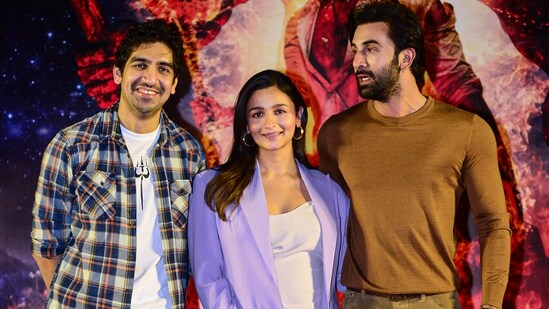 Ranbir Kapoor and Alia Bhatt, and director Ayan Mukerji pose for photos during a press conference for the promotion of their film Brahmastra.