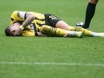 Dortmund's Marco Reus is injured on the ground during the German Bundesliga soccer match between Borussia Dortmund and FC Schalke 04 (AP) Dortmund's Marco Reus is injured on the ground during the German Bundesliga soccer match between Borussia Dortmund and FC Schalke 04 (AP)