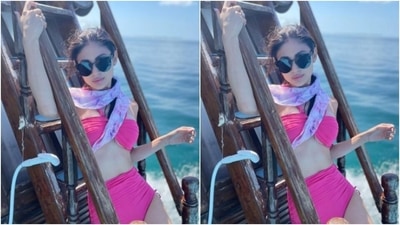 Mouni’s pink bikini featured halterneck details and a plunging neckline. She teamed it with a pair of high-waisted pink lowers. (Instagram/@imouniroy)