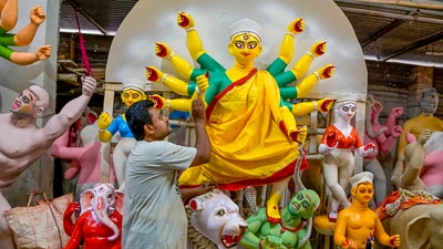 An artisan paints a clay idol of Goddess Durga at a workshop, ahead of the celebrations of Durga Puja, in Nadia, West Bengal. (PTI) An artisan paints a clay idol of Goddess Durga at a workshop, ahead of the celebrations of Durga Puja, in Nadia, West Bengal. (PTI)