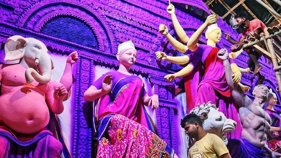 Artists give final touches to the idols of Goddess Durga at a community puja pandal, ahead of Durga puja festival, at Balurghat, in South Dinajpur.(ANI)