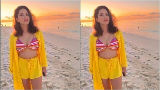 Sunny decked up in a multicoloured bra and teamed it with a pair of bright yellow shorts. She added more beach vibes with an oversized yellow shrug featuring full sleeves.(Instagram/@sunnyleone)