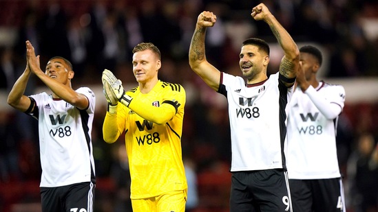 Fulham's Carlos Vinicius, left, goalkeeper Bernd Leno and Aleksandar Mitrovic celebrate after the final whistle of the Premier League soccer match(AP)