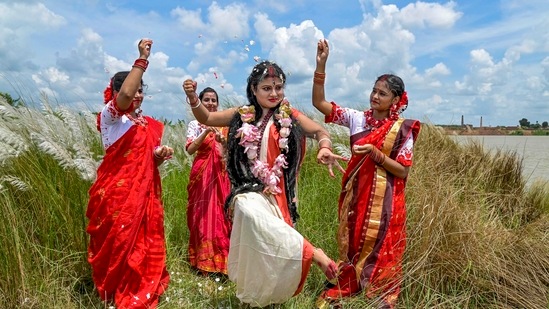 Folk artists perform an act to depict 'Mahishasura Mardini' ahead of Durga Puja festival in Nadia district of West Bengal.(PTI)