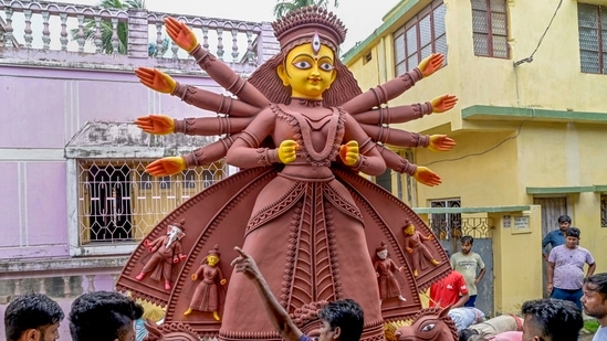 A clay idol of Goddess Durga being loaded into a truck for transportation ahead of the Durga Puja festival, in Nadia, West Bengal.(PTI)