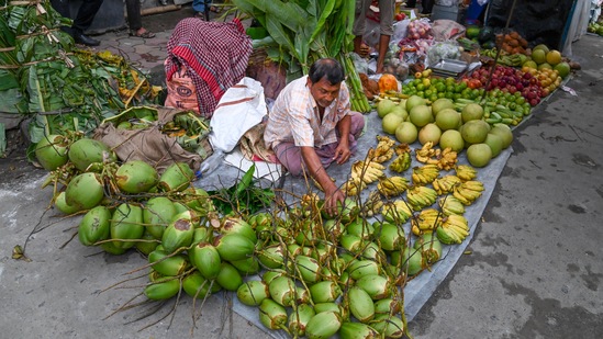 A vendor sells fruits meant to be used as offerings for Lord Vishwakarma in Kolkata.(PTI)