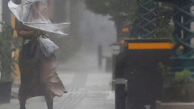 Typhoon Nanmadol In Japan: A woman makes her way through the strong wind and rain in Miyazaki, southern Japan. (AP) Typhoon Nanmadol In Japan: A woman makes her way through the strong wind and rain in Miyazaki, southern Japan. (AP)