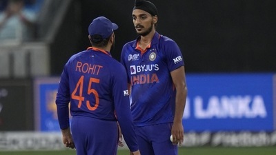India's Arshdeep Singh, right, listens to captain Rohit Sharma (AP) India's Arshdeep Singh, right, listens to captain Rohit Sharma (AP)