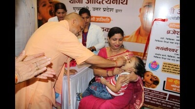U.P. chief minister Yogi Adityanath administering a polio drop to a kid at an event in Lucknow on Sunday. (Sourced) U.P. chief minister Yogi Adityanath administering a polio drop to a kid at an event in Lucknow on Sunday. (Sourced)