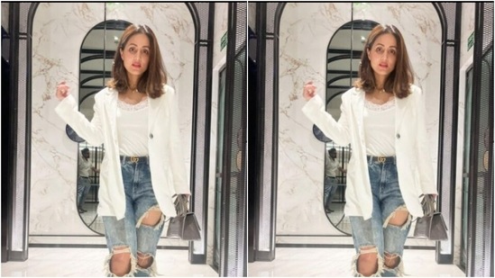 Hina decked up in a white laced top and teamed it with a formal white blazer. She added casual vibes to her look with a pair of blue distressed denims.(Instagram/@realhinakhan)