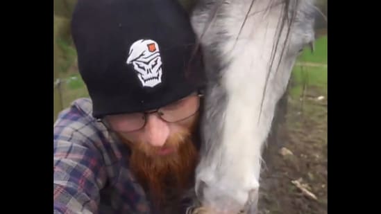 The man cuddles with his horse in this video.&nbsp;(Reddit/@kriskirby86)