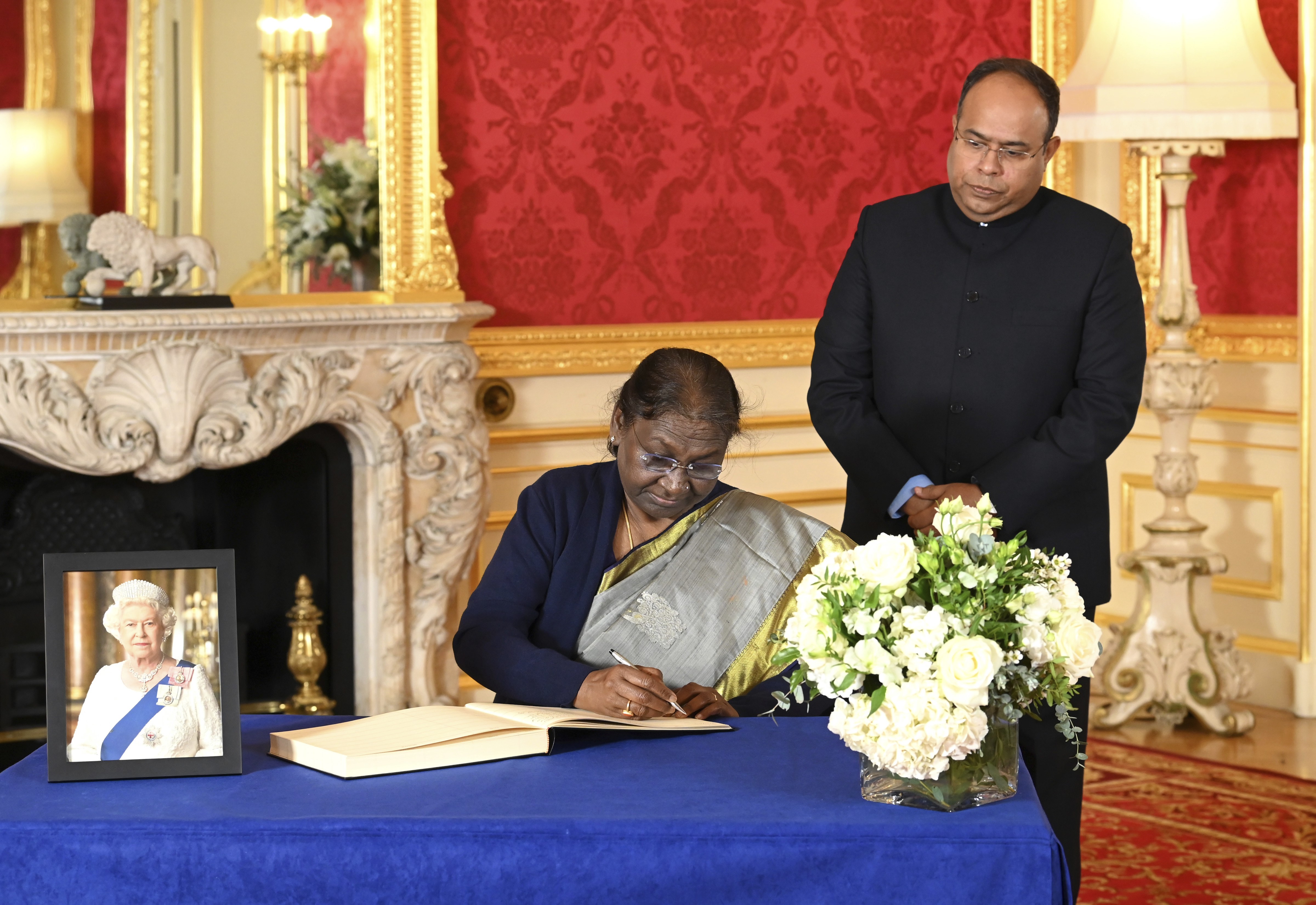 President Droupadi Murmu and acting high commissioner Sujit Ghosh sign a book of condolences at Lancaster House following the death of Queen Elizabeth II in London. (AP) President Droupadi Murmu and acting high commissioner Sujit Ghosh sign a book of condolences at Lancaster House following the death of Queen Elizabeth II in London. (AP)