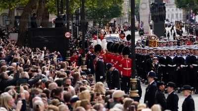 Queen Elizabeth II's Funeral: Crowds watch as the State Gun Carriage carries the coffin of Queen Elizabeth II. (Reuters)