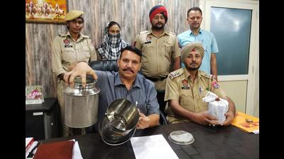 The woman arrested for smuggling opium in milk container in Jalandhar Rural police custody on Monday. (HT Photo)