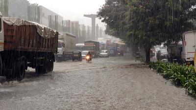 Vehicles move through a waterlogged road amid heavy rainfall in Thane. (ANI Photo) Vehicles move through a waterlogged road amid heavy rainfall in Thane. (ANI Photo)