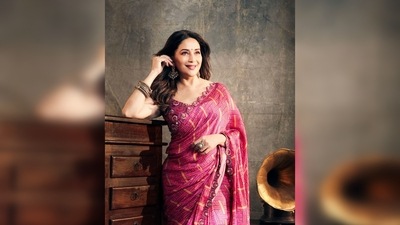 Madhuri Dixit draped a rani pink, block printed saree in geometrical motifs from the collection of designer Punit Balana. (Instagram/@madhuridixit)