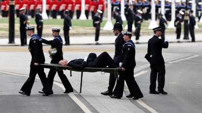 A Policeman collapses at the funeral of the Queen, Westminster Abbey, London on Monday. (via REUTERS)