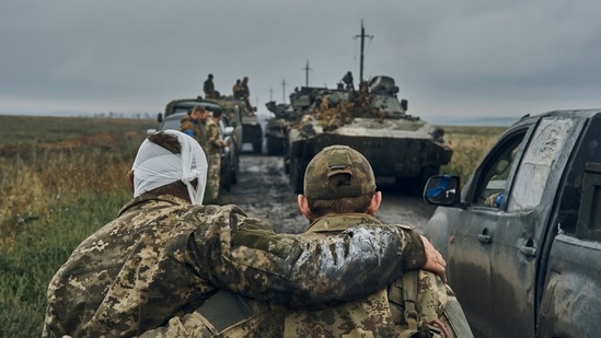 Russia-Ukraine War: A Ukrainian soldier helps a wounded fellow soldier on the road in the freed territory in the Kharkiv region, Ukraine. (AP) Russia-Ukraine War: A Ukrainian soldier helps a wounded fellow soldier on the road in the freed territory in the Kharkiv region, Ukraine. (AP)