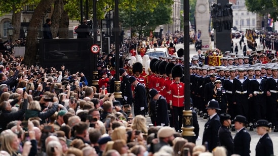 Queen Elizabeth II's Funeral: Crowds watch as the State Gun Carriage carries the coffin of Queen Elizabeth II.(Reuters)