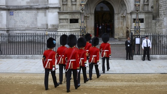 Soldiers in ceremonial uniform walk into Westminster Abbey, on the day of the Queen Elizabeth II funeral, at Westminster Abbey in London.(AP)