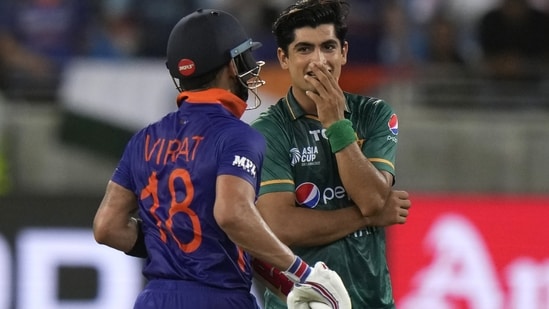 Pakistan's Naseem Shah, right, reacts after bowling a delivery to India's Virat Kohli(AP)