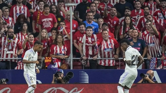 Rodrygo, left, celebrates after scoring with his teammate Real Madrid's Vinicius Junior the opening goal during the Spanish La Liga match between Atletico Madrid and Real Madrid at the Wanda Metropolitano&nbsp;(AP)