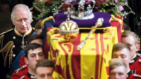 King Charles III and members of the Royal family follow behind the coffin of Queen Elizabeth II, draped in the Royal Standard with the Imperial State Crown and the Sovereign's orb and sceptre, as it is carried out of Westminster Abbey after her State Funeral, in London, on Monday. (AP/PTI Photo)