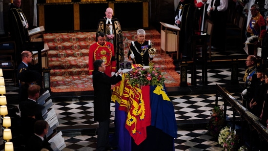 Members of the royal family watch as the Imperial State Crown is removed from the coffin during the Committal Service for Britain's Queen Elizabeth II in St George's Chapel inside Windsor Castle on Monday. (Photo by Ben Birchall/POOL/AFP)