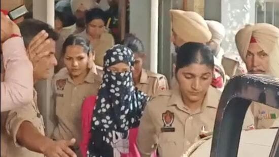 Chandigarh University ‘video leak’ row: The 22-year-old accused woman taken away by cops after she was presented in court. (SANJEEV SHARMA/HT)