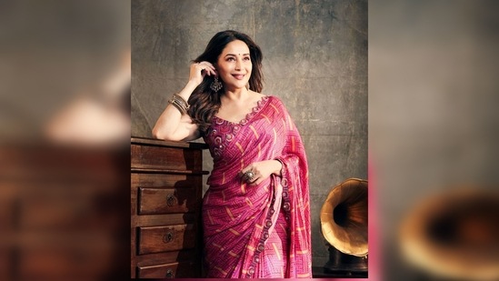 The saree has been lined with delicate resham and mirror embroidery and has been paired with a heavily worked blouse.(Instagram/@madhuridixt)