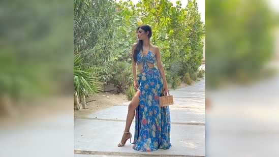 Mouni Roy's dress features a cut waist halter neck gown and a side slit. She shared a string of images and captioned her post, "As far as the double life goes ours isn’t as cool as Clark Kent but we do get to act & dance!."(Instagram/@imouniroy)