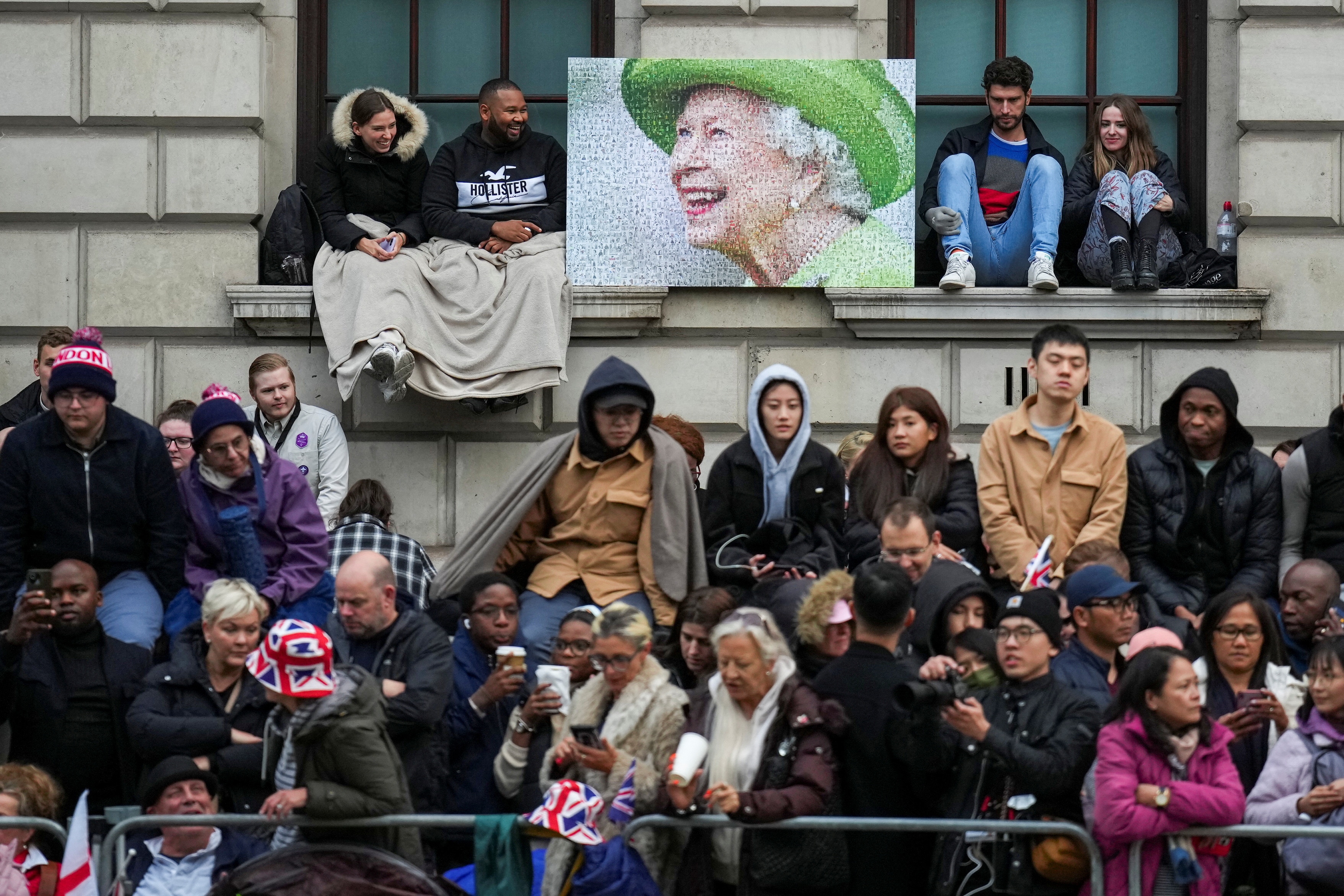 People wait along the route that the coffin of Queen Elizabeth II will be pulled on a gun carriage following her funeral service in Westminster Abbey in central London Monday Sept. 19, 2022. Emilio Morenatti/Pool via REUTERS (via REUTERS)