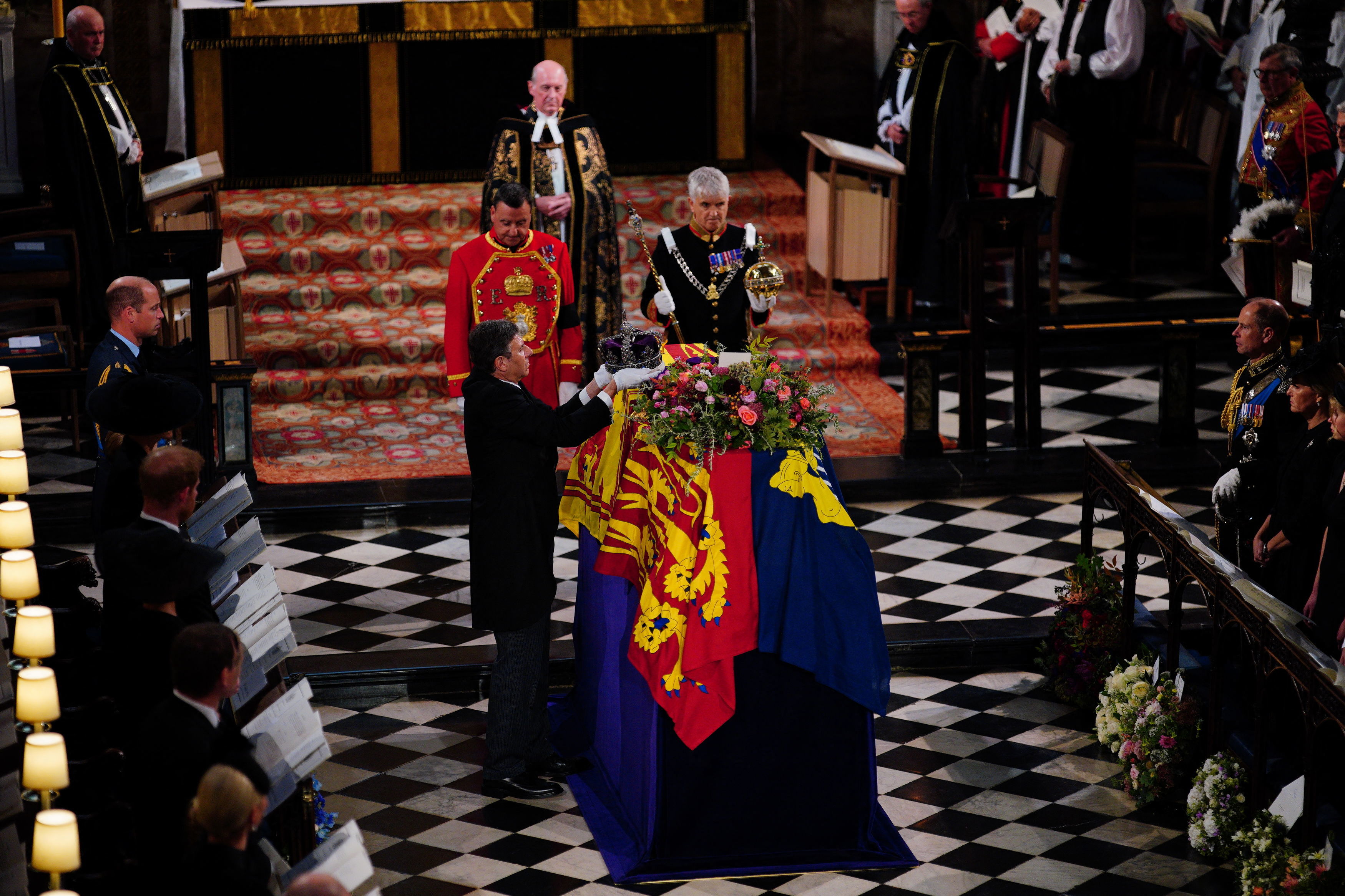 Members of the royal family watch as the Imperial State Crown is removed from the coffin during the Committal Service for Britain's Queen Elizabeth II in St George's Chapel inside Windsor Castle on Monday. (Photo by Ben Birchall/POOL/AFP)
