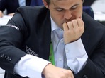 Norwegian Chess Grandmaster Magnus Carlsen makes a move during a match of 10th round at the 44th FIDE Chess Olympiad Norwegian Chess Grandmaster Magnus Carlsen makes a move during a match of 10th round at the 44th FIDE Chess Olympiad