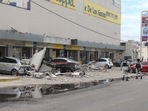 Vehicles damaged by the collapse of the facade of a department store during an earthquake, in Manzanillo, Mexico.&nbsp;