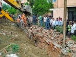 Noida: Rescue operation underway after a portion of a boundary wall of a housing society collapsed, at Jal Vayu Vihar in Noida, Tuesday, (PTI Photo) Noida: Rescue operation underway after a portion of a boundary wall of a housing society collapsed, at Jal Vayu Vihar in Noida, Tuesday, (PTI Photo)