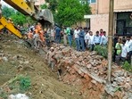 Noida: Rescue operations after a portion of a boundary wall of a housing society collapsed, at Jal Vayu Vihar in Noida, Tuesday, (PTI Photo) Noida: Rescue operations after a portion of a boundary wall of a housing society collapsed, at Jal Vayu Vihar in Noida, Tuesday, (PTI Photo)