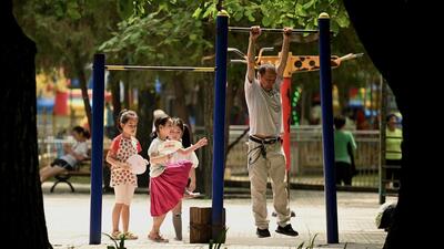 Children and an adult are seen at a park in Beijing on August 2, 2022. Given China’s average life expectancy is now 78.2 years, as per NHC latest data released in July, the number of elderly citizens is increasing. (AFP) Children and an adult are seen at a park in Beijing on August 2, 2022. Given China’s average life expectancy is now 78.2 years, as per NHC latest data released in July, the number of elderly citizens is increasing. (AFP)