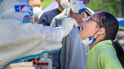 Covid In China: A health worker taking a swab sample from a young resident in China. (AFP)