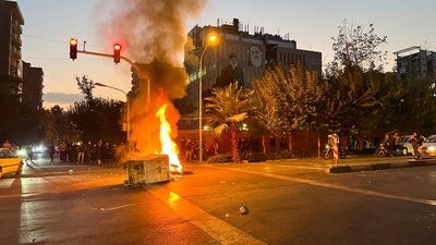 A police motorcycle burns during a protest over the death of Mahsa Amini, a woman who died after being arrested by the Islamic republic's "morality police", in Tehran, Iran. (via REUTERS)