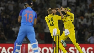 Australia's Nathan Ellis, center, celebrates with a teammate after the dismissal of India's Virat Kohli (AP)