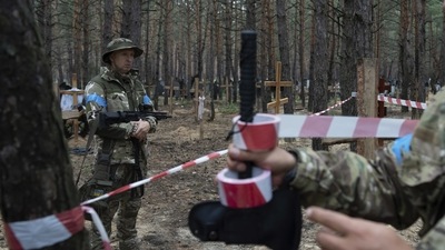 Oleg Kotenko, the Commissioner for Issues of Missing Persons under Special Circumstances looks at the unidentified graves of civilians and Ukrainian soldiers in the recently retaken area of Izium, Ukraine, Thursday, Sept. 15, 2022 who had been killed by Russian forces near the beginning of the war (AP Photo/Evgeniy Maloletka) Oleg Kotenko, the Commissioner for Issues of Missing Persons under Special Circumstances looks at the unidentified graves of civilians and Ukrainian soldiers in the recently retaken area of Izium, Ukraine, Thursday, Sept. 15, 2022 who had been killed by Russian forces near the beginning of the war (AP Photo/Evgeniy Maloletka)